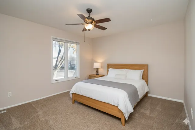 a bedroom with a bed and window