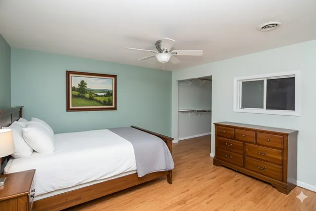 a bedroom with a bed and a dresser