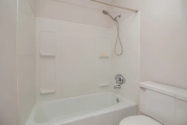 a bathroom with a bath tub with a shower