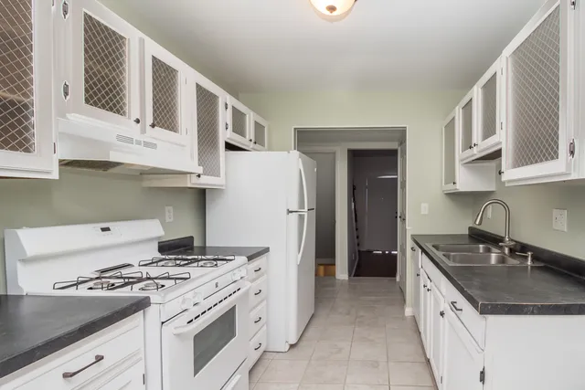 a kitchen with stainless steel appliances granite countertop a stove and a sink