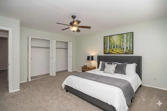 a bedroom with a bed and a chandelier