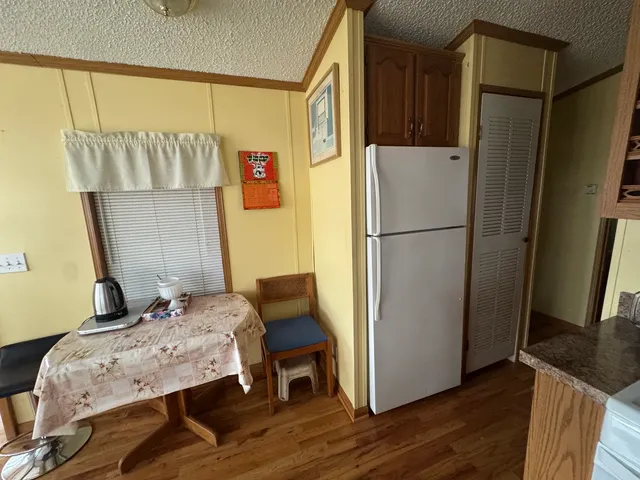 a refrigerator freezer sitting inside of a kitchen