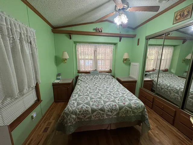 a bedroom with a bed and a large window