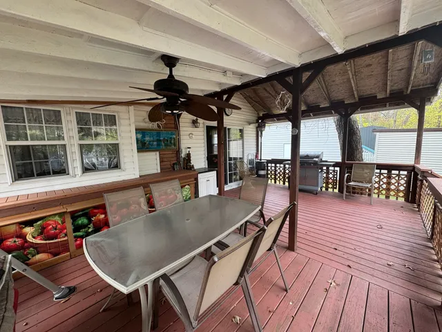 a dining room with wooden floor a table and chairs