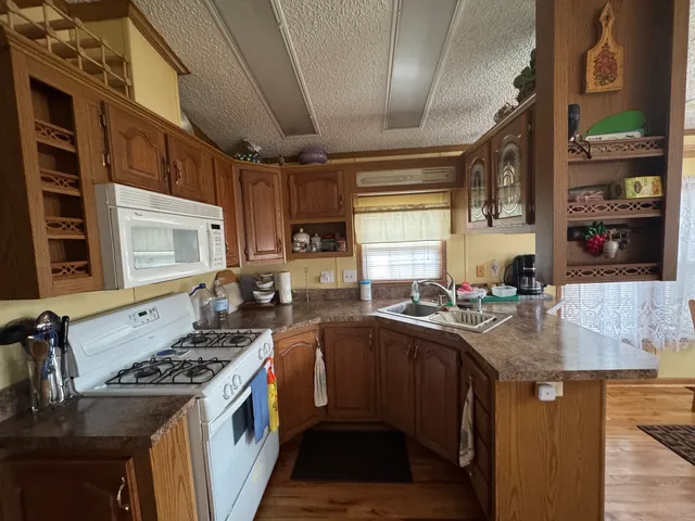 a kitchen with stainless steel appliances granite countertop a sink stove and cabinets