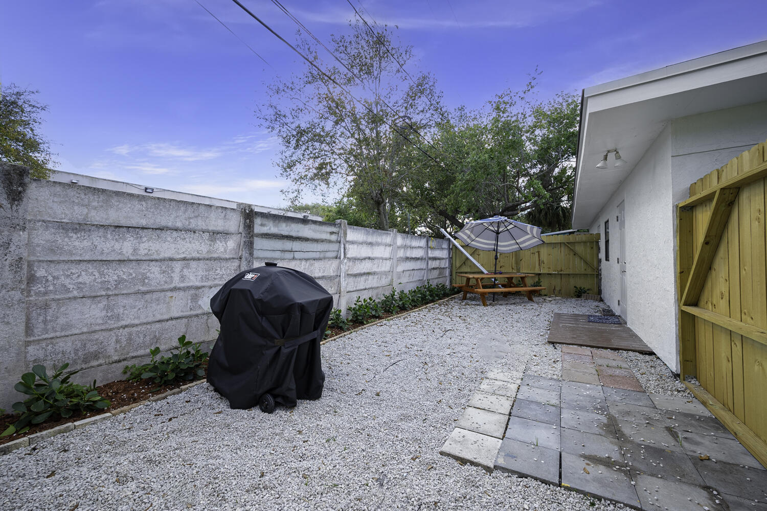 1718 Ridge Road North Palm Beach, FL 33408 - Photo 15 of 39 a view of a patio with table and chairs and potted plants