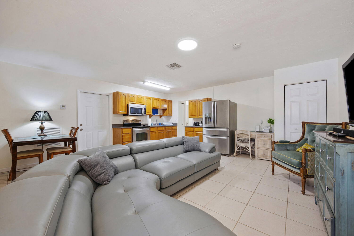 1718 Ridge Road North Palm Beach, FL 33408 - Photo 2 of 39 a living room with furniture and a flat screen tv