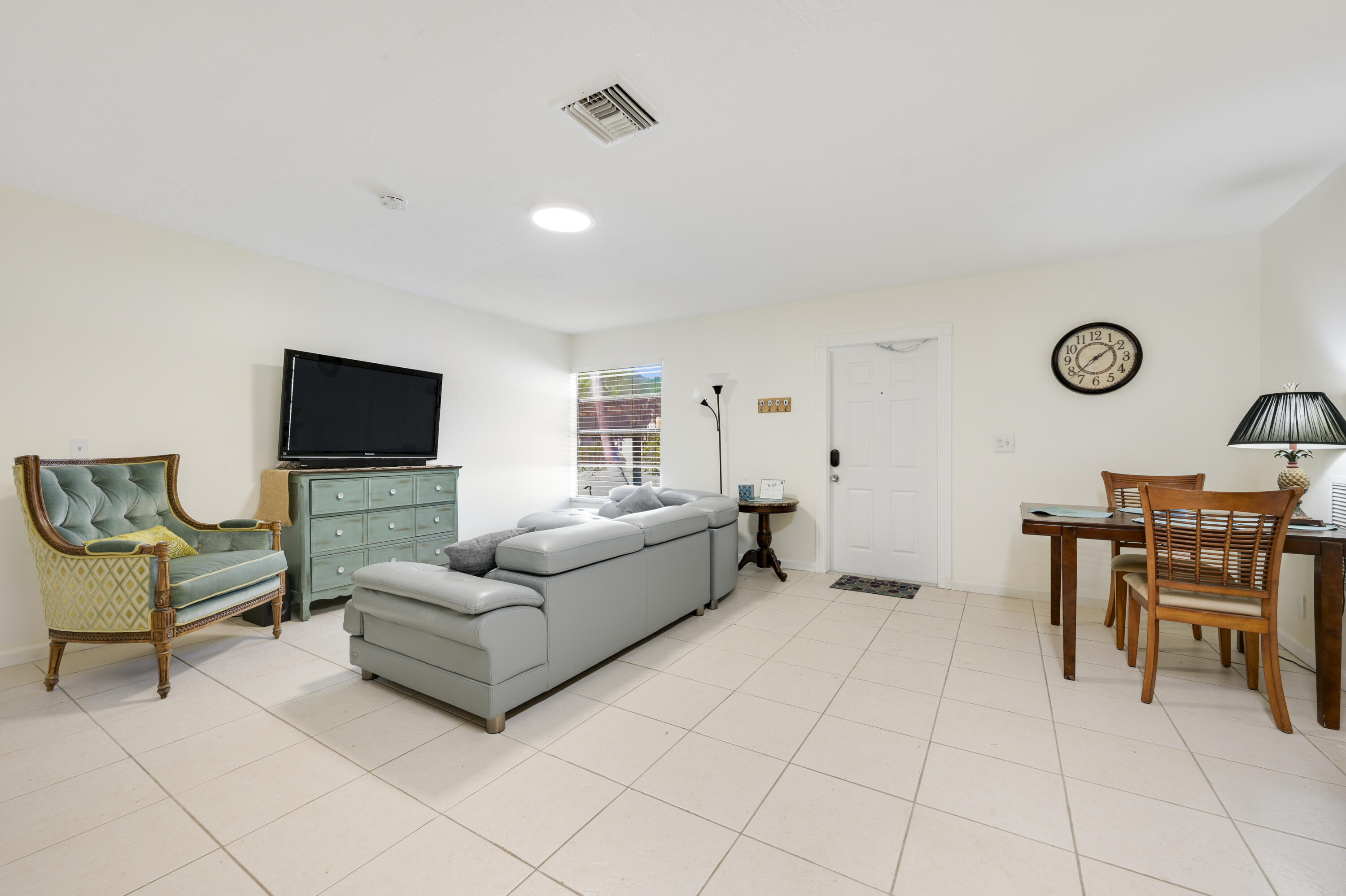 1718 Ridge Road North Palm Beach, FL 33408 - Photo 3 of 39 a living room with furniture and a flat screen tv