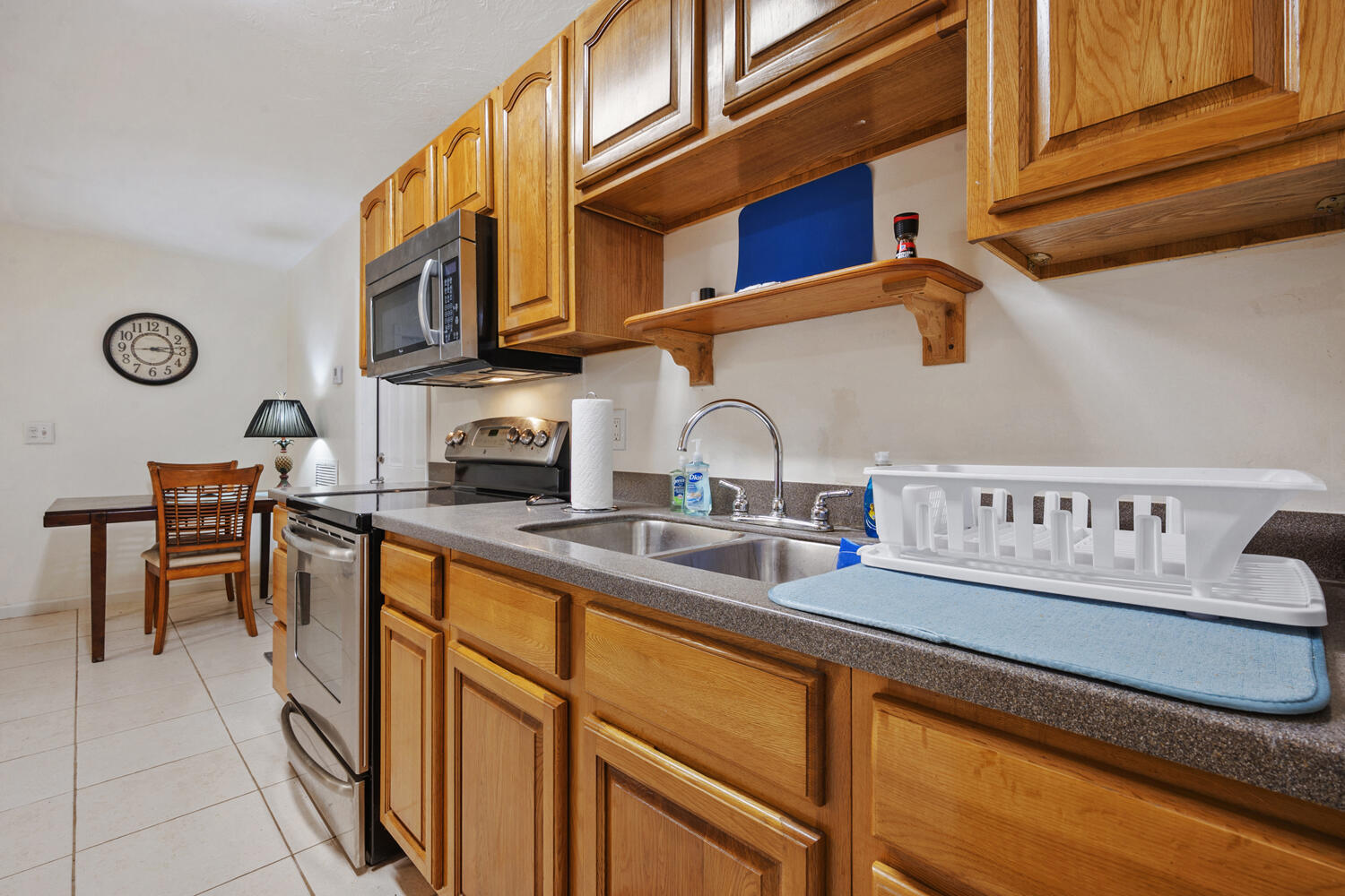 1718 Ridge Road North Palm Beach, FL 33408 - Photo 5 of 39 a kitchen with stainless steel appliances granite countertop a sink and cabinets