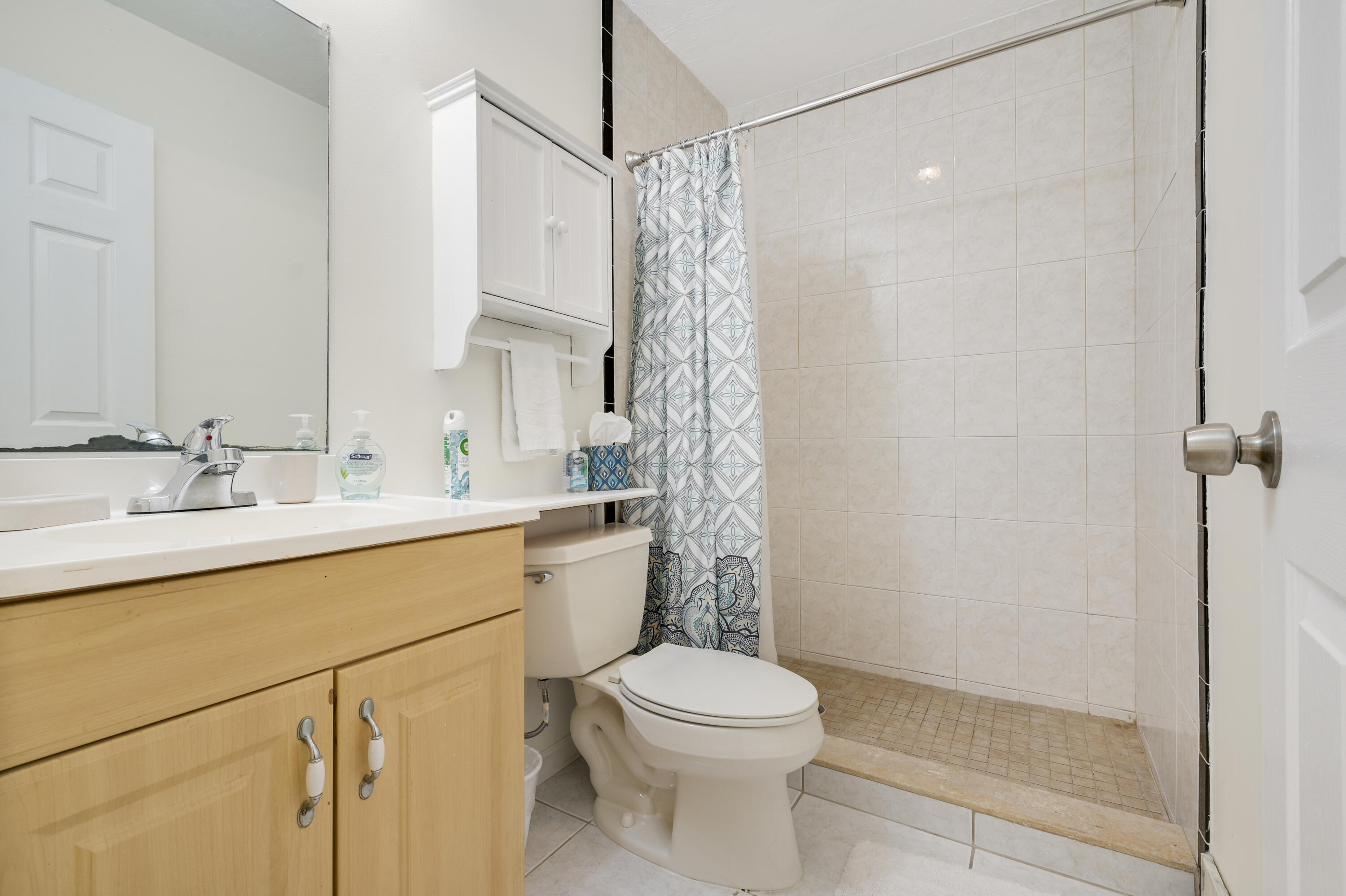 1718 Ridge Road North Palm Beach, FL 33408 - Photo 9 of 39 a bathroom with a shower a sink a toilet and shower