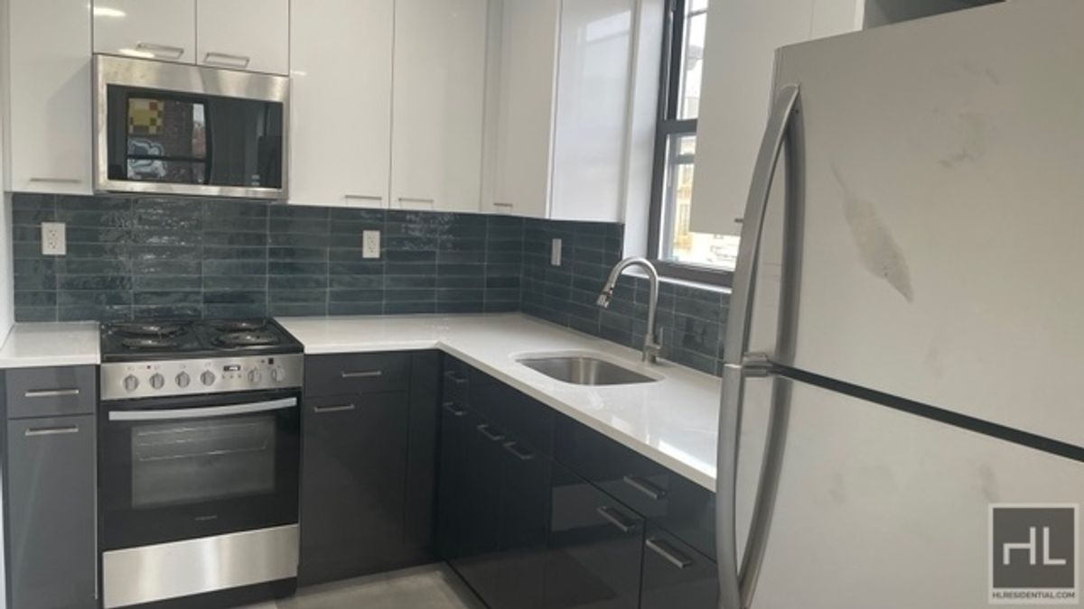 a kitchen with a sink and a refrigerator
