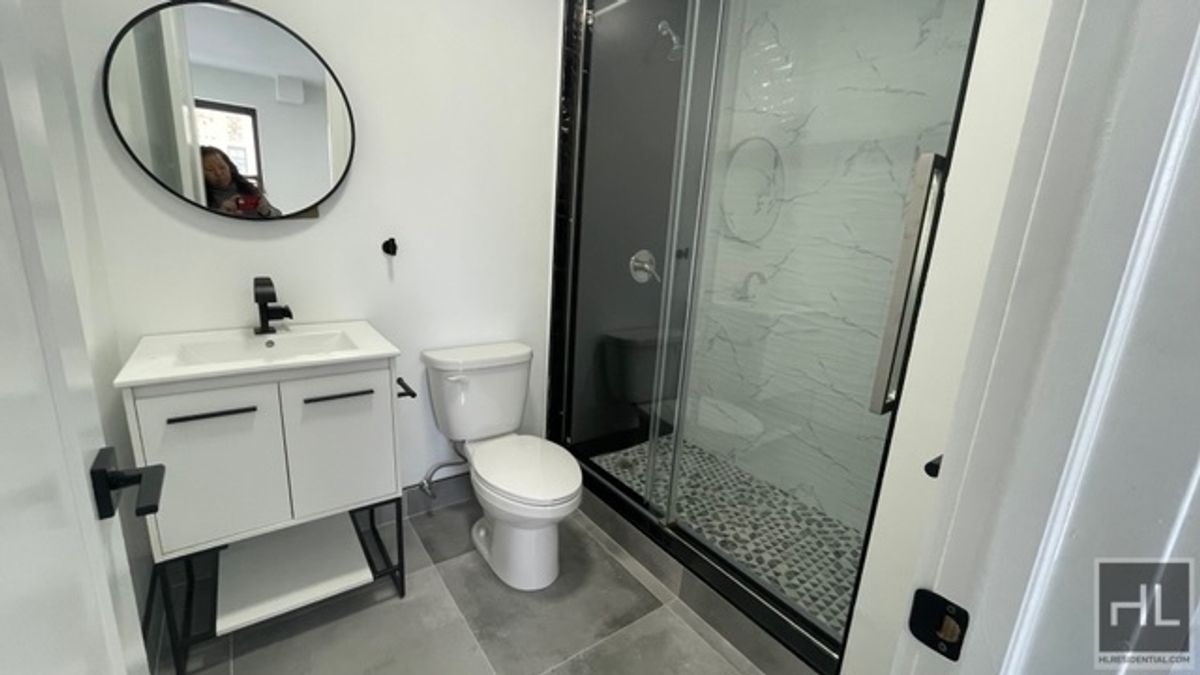 237 Utica Avenue, Unit 2R Brooklyn, NY 11213 - Photo 13 of 34 a bathroom with a sink toilet a mirror and tub