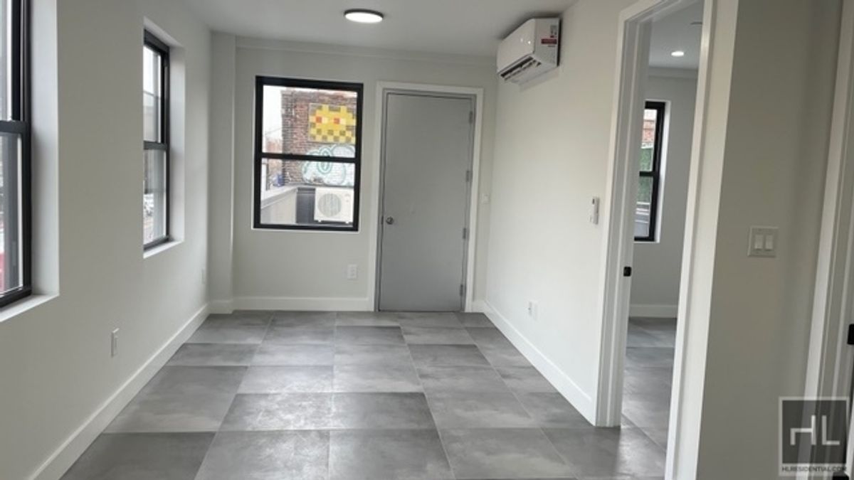 237 Utica Avenue, Unit 2R Brooklyn, NY 11213 - Photo 5 of 34 an empty room that has a window in it and wooden floor