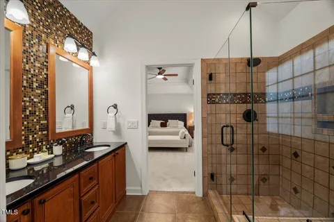 a bedroom with a large bed and a chandelier