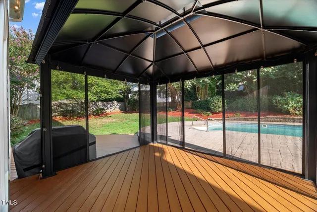 a view of a big room with windows and chandelier fan