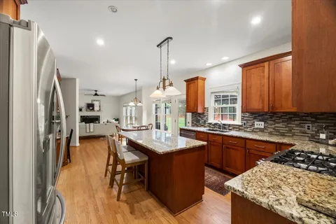 a view of a dining room with furniture wooden floor and chandelier