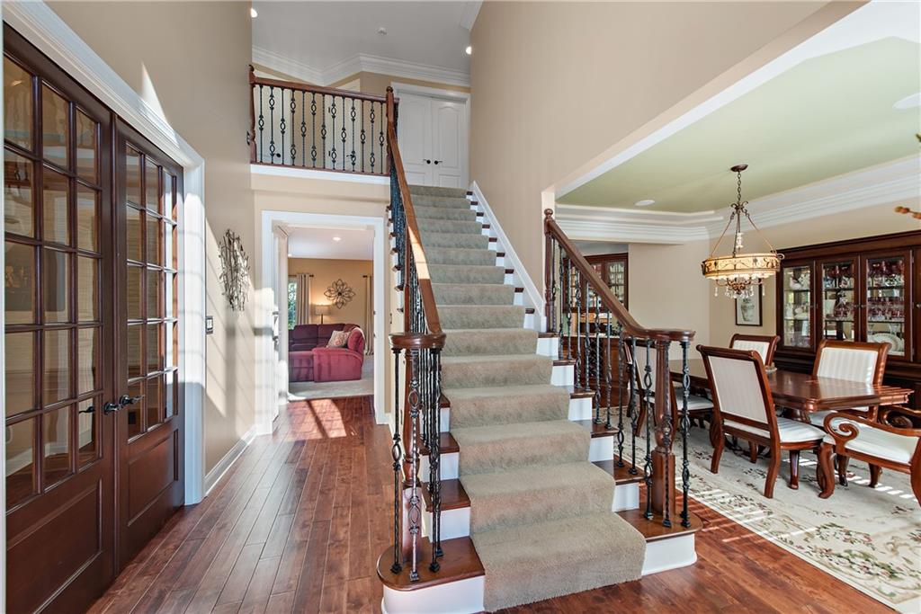 a view of a hallway with wooden floor and staircase