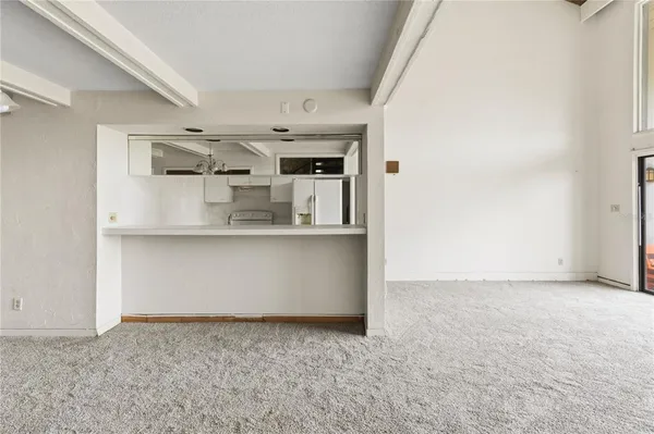 a view of kitchen cabinets and window