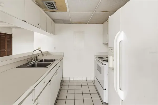 a kitchen with a refrigerator and a sink