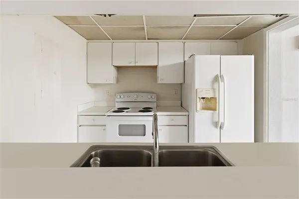 a kitchen with a sink and a refrigerator