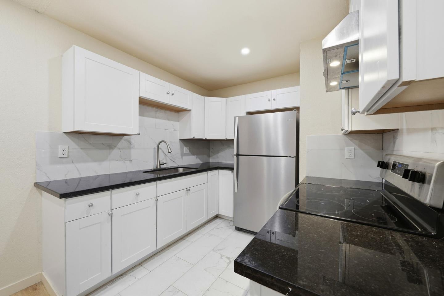 7283 Florin Road, Unit 8 Sacramento, CA 95828 - Photo 13 of 35 a kitchen with granite countertop a sink stainless steel appliances and cabinets