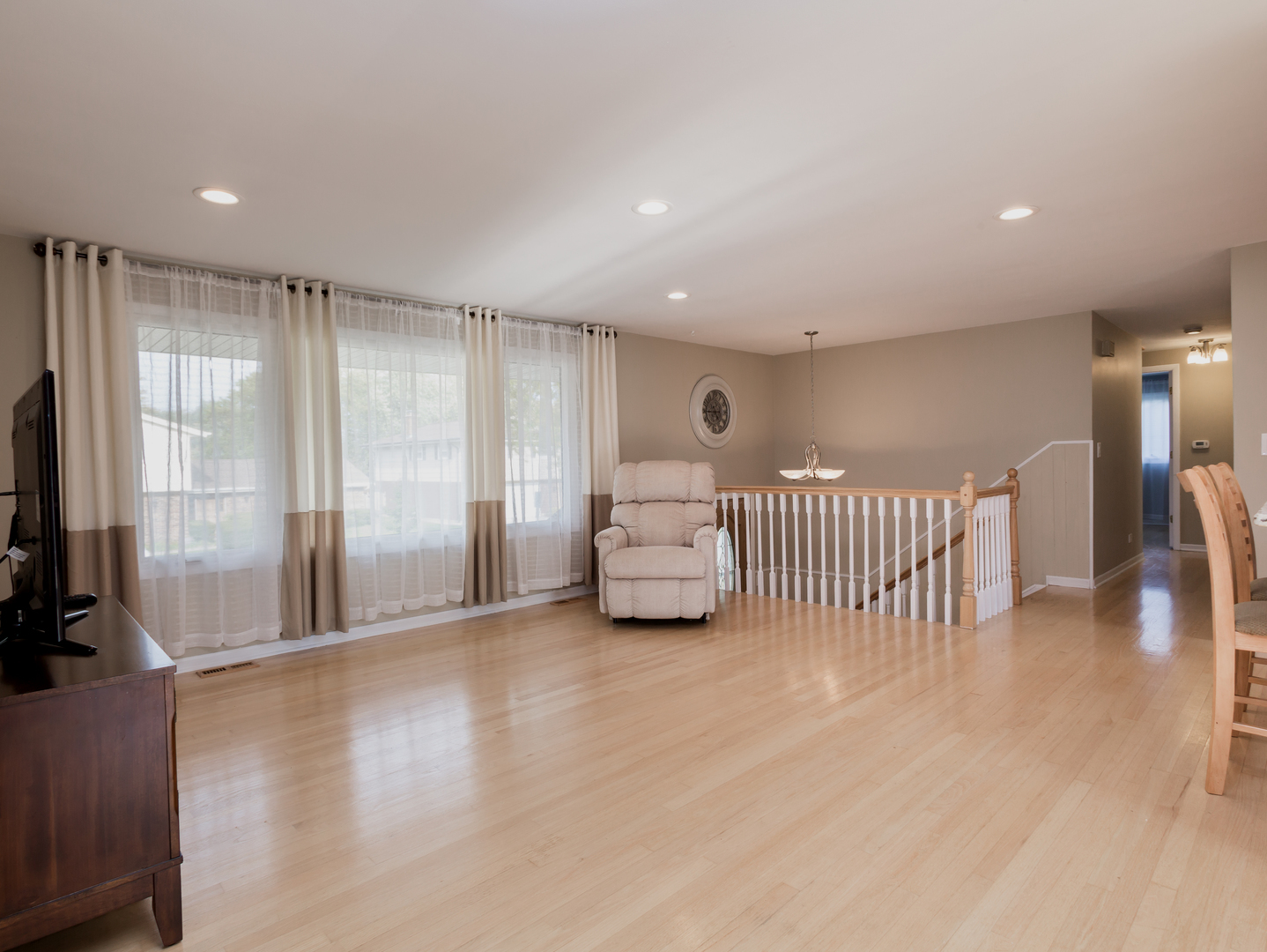 829 Pinehurst Lane Schaumburg, IL 60193 - Photo 13 of 45 an empty room with wooden floor and windows