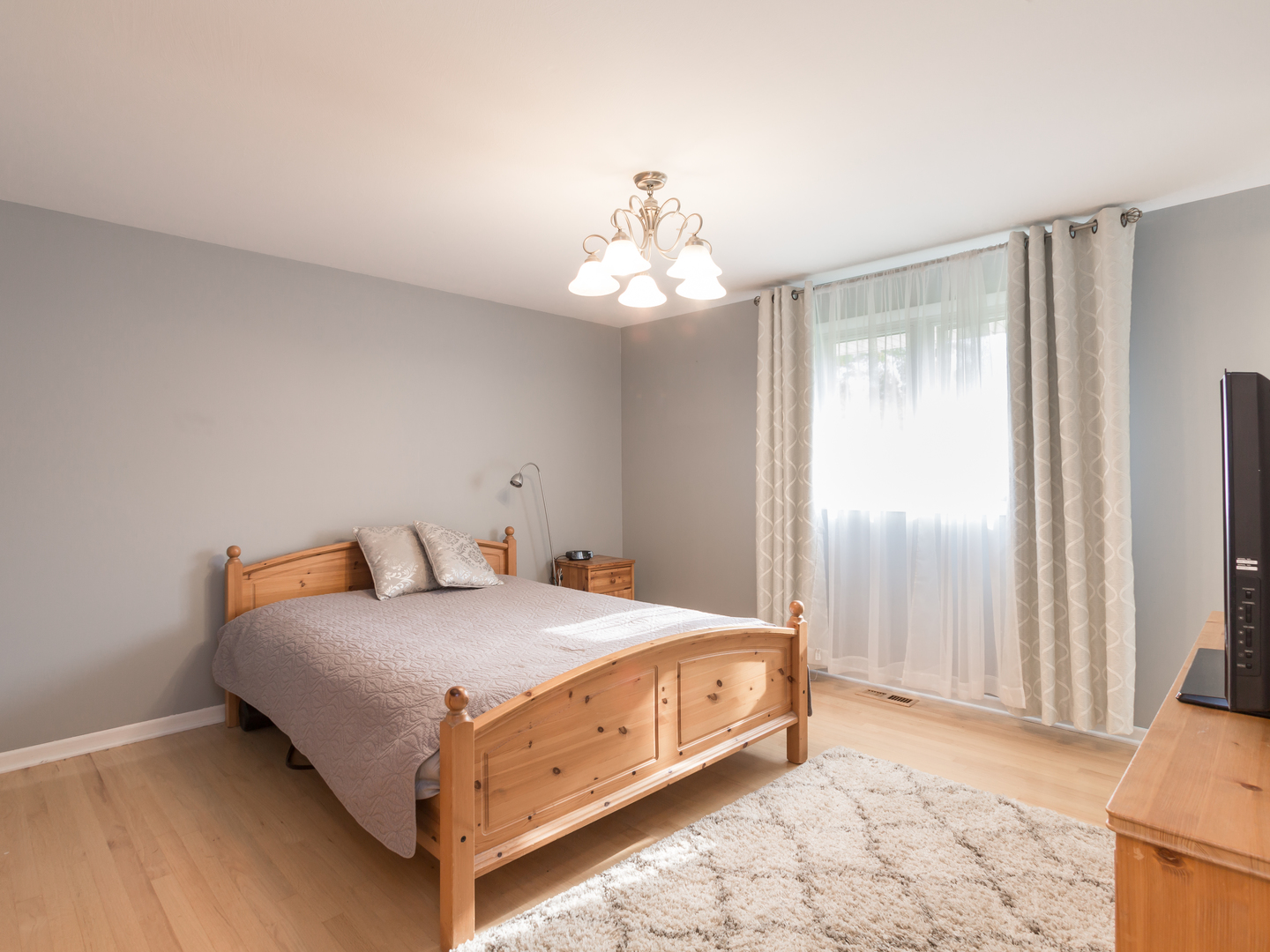 829 Pinehurst Lane Schaumburg, IL 60193 - Photo 16 of 45 a bedroom with a bed and a chandelier