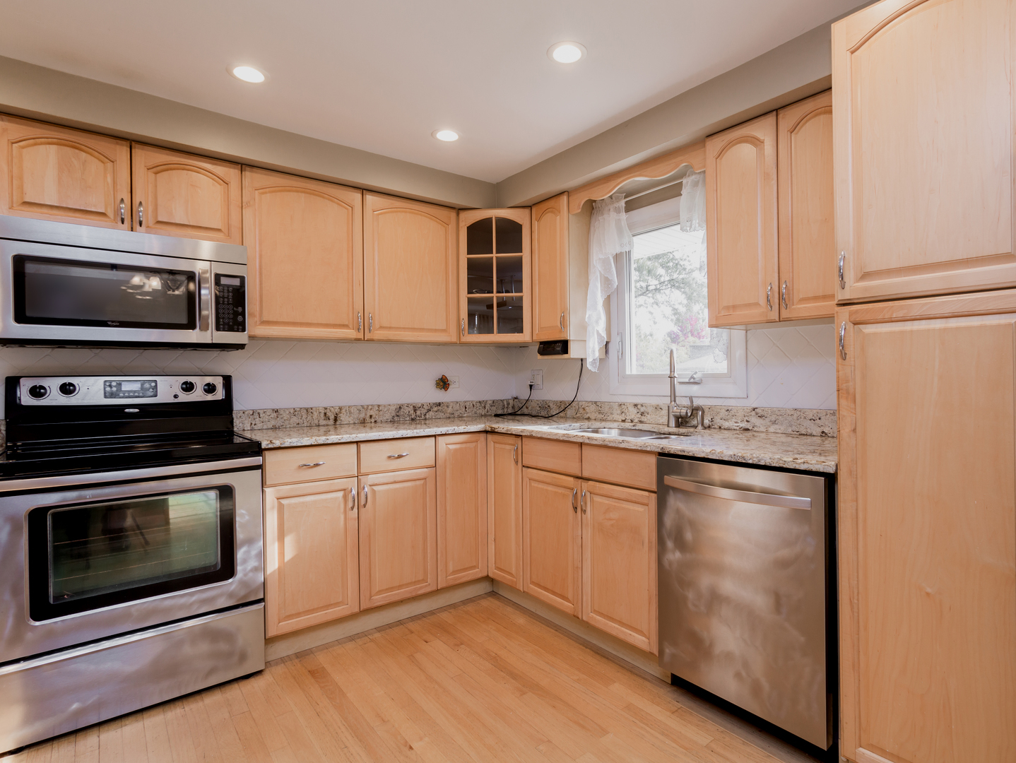 829 Pinehurst Lane Schaumburg, IL 60193 - Photo 3 of 45 a kitchen with granite countertop cabinets stainless steel appliances and a sink