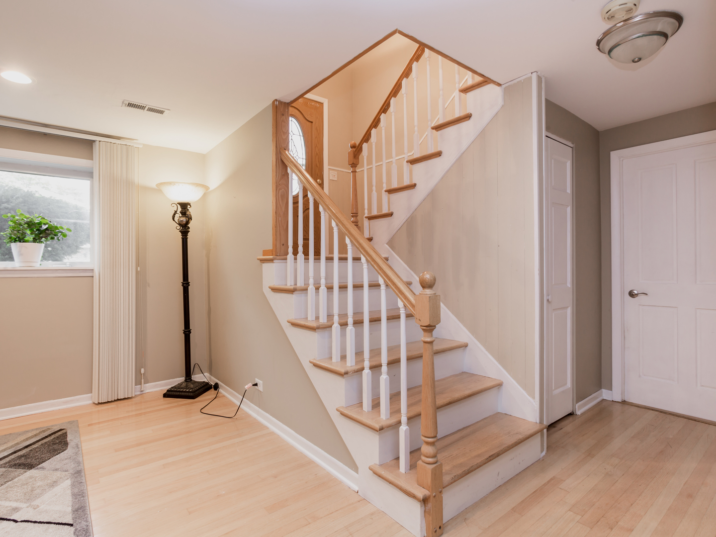 829 Pinehurst Lane Schaumburg, IL 60193 - Photo 31 of 45 a view of staircase with white walls and a window