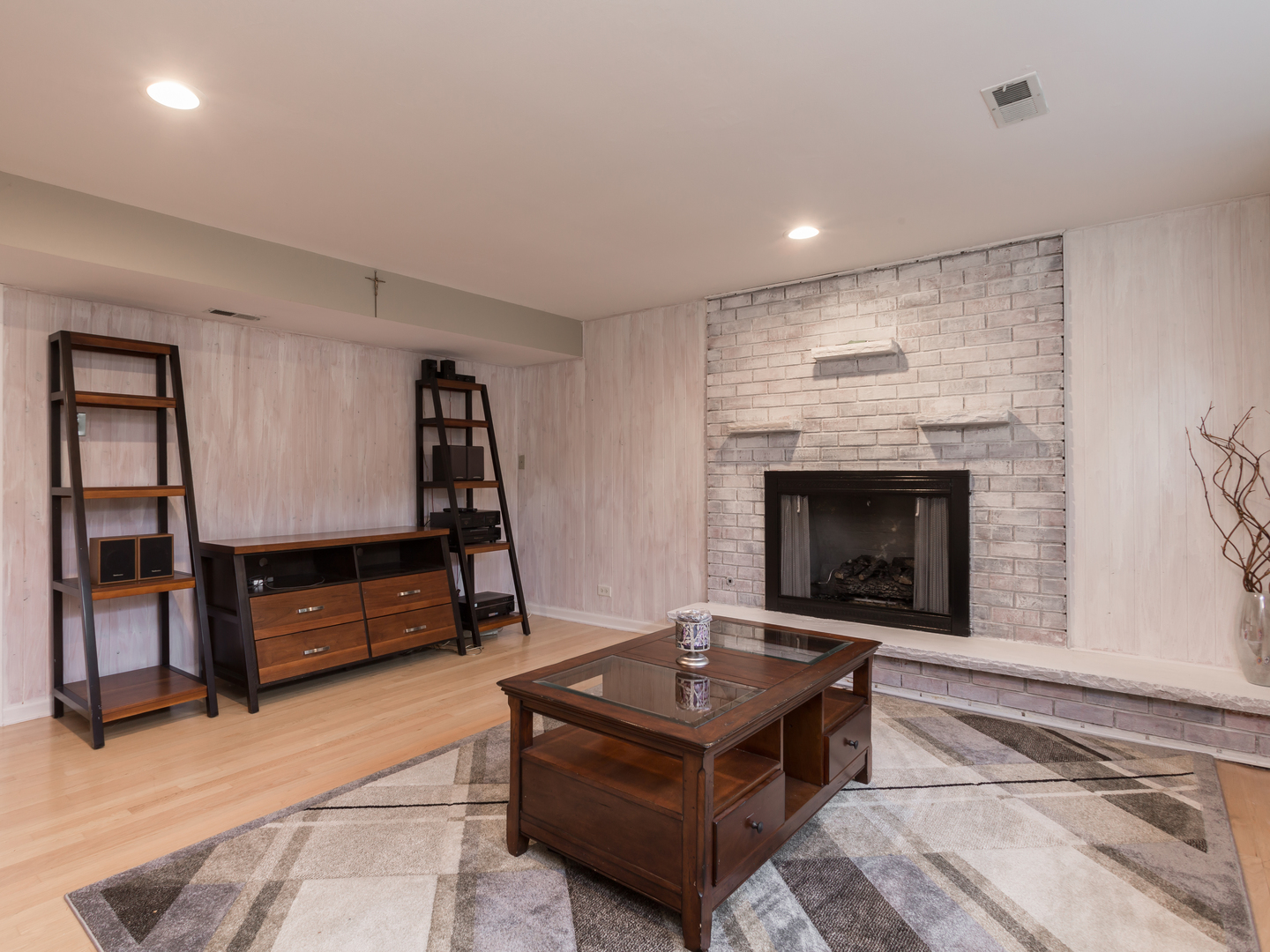829 Pinehurst Lane Schaumburg, IL 60193 - Photo 32 of 45 a living room with furniture a flat screen tv and a fireplace