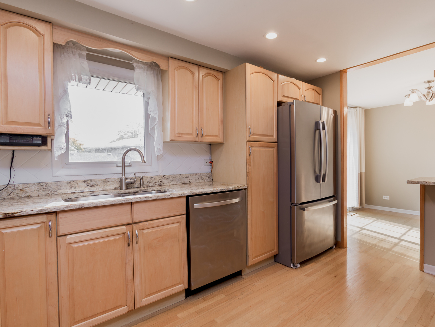829 Pinehurst Lane Schaumburg, IL 60193 - Photo 5 of 45 a kitchen with granite countertop a refrigerator sink and cabinets