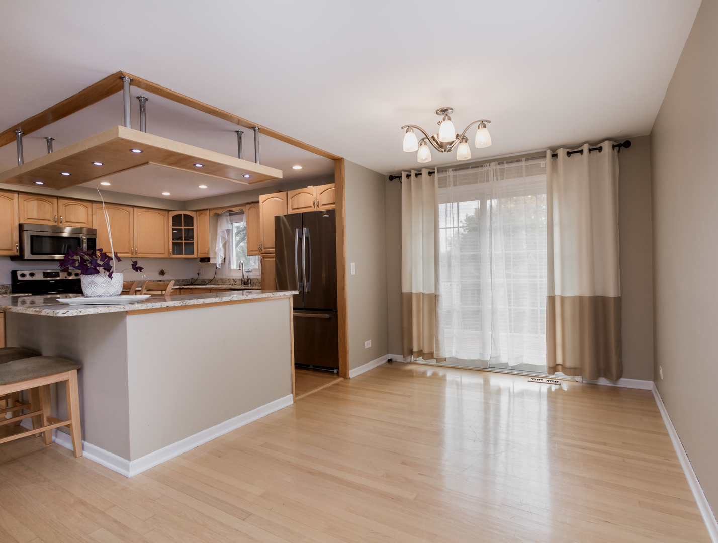 829 Pinehurst Lane Schaumburg, IL 60193 - Photo 9 of 45 a view of kitchen with refrigerator and window