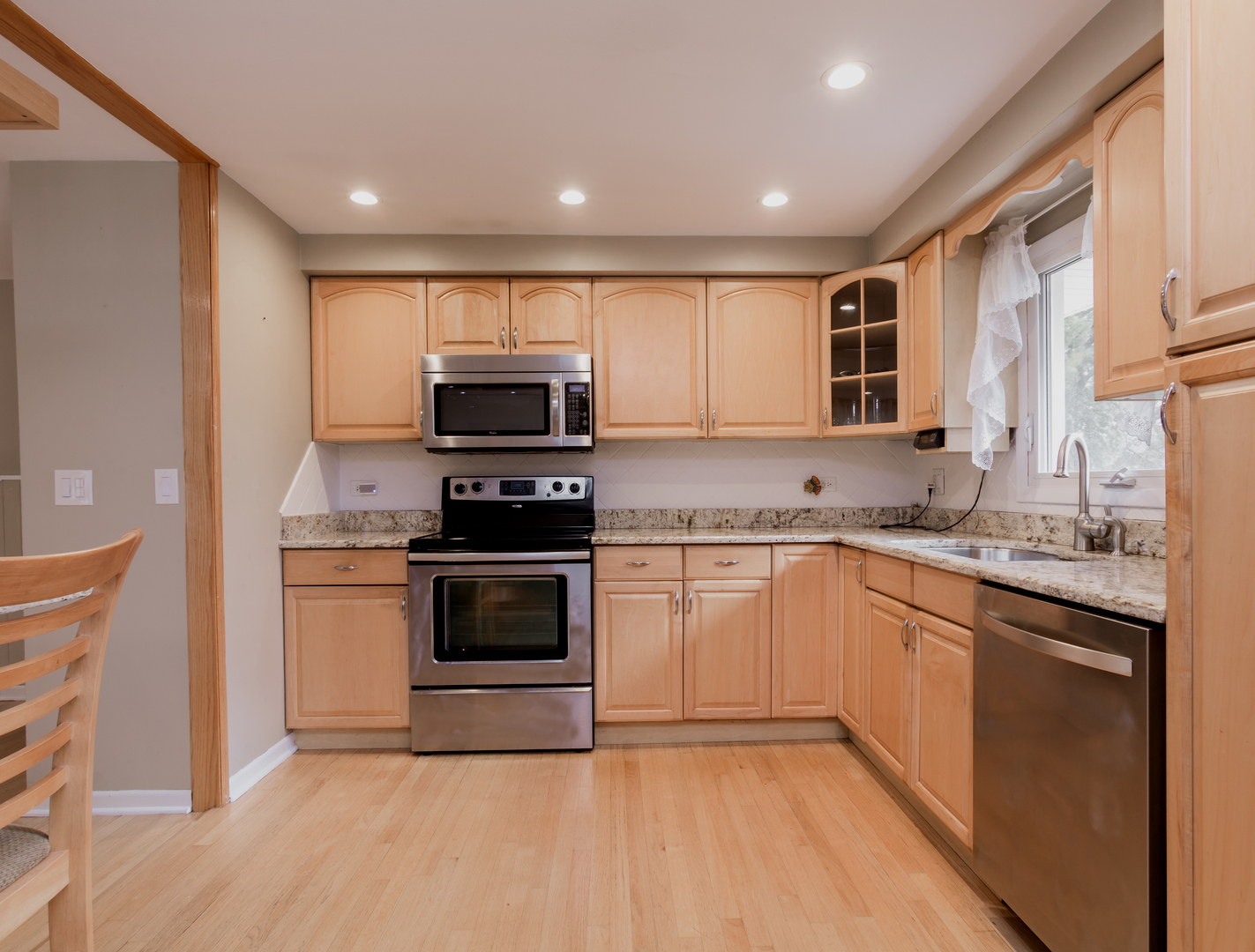 829 Pinehurst Lane Schaumburg, IL 60193 - Photo 10 of 45 a kitchen with stainless steel appliances granite countertop a stove a sink and a microwave