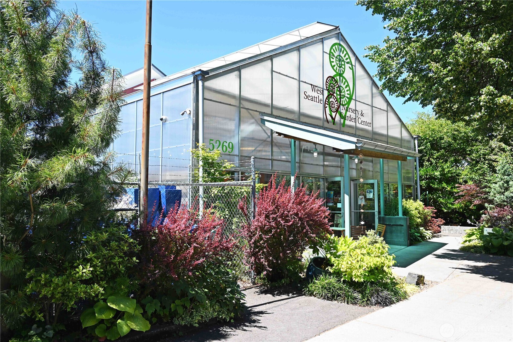 6408 Fauntleroy Way Southwest Seattle, WA 98136 - Photo 32 of 40 a view of a house with fountain and a flower garden