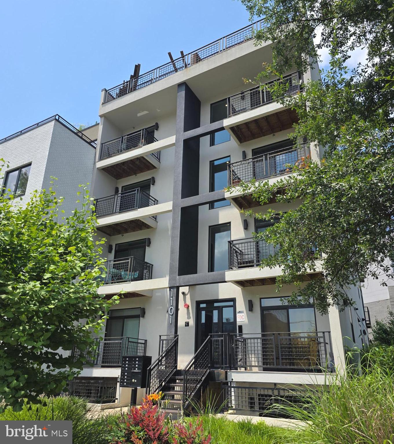 a front view of a building with a garden