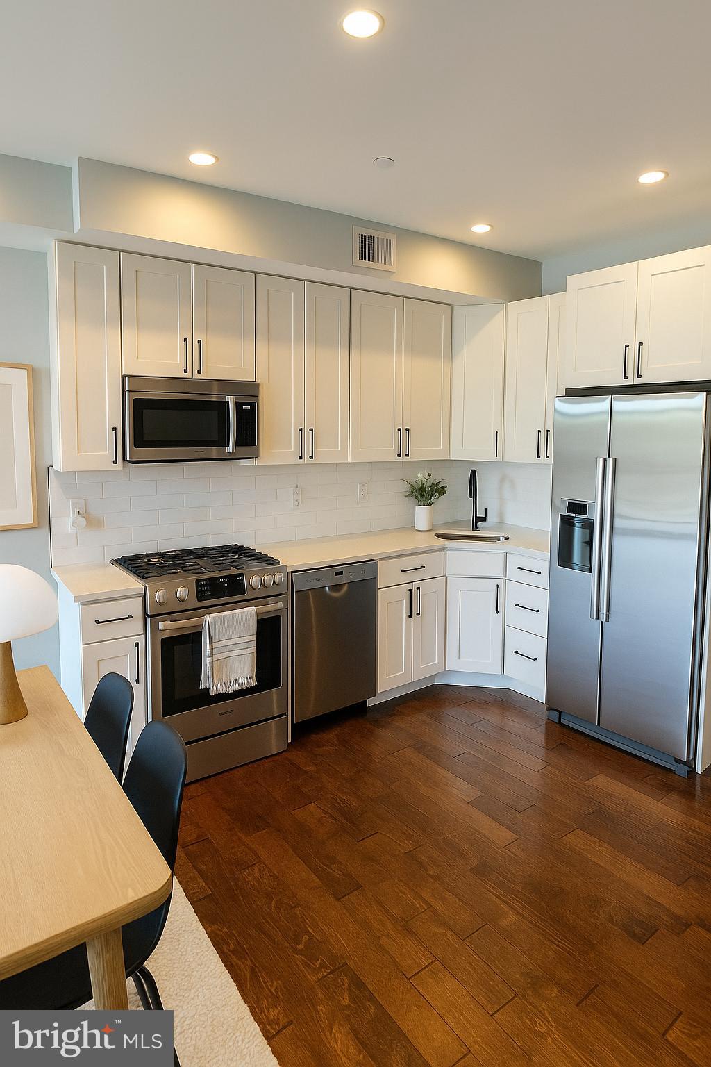 1101 Fern Street Northwest, Unit 301 Washington, DC 20012 - Photo 13 of 25 a kitchen with a stove a sink and a refrigerator