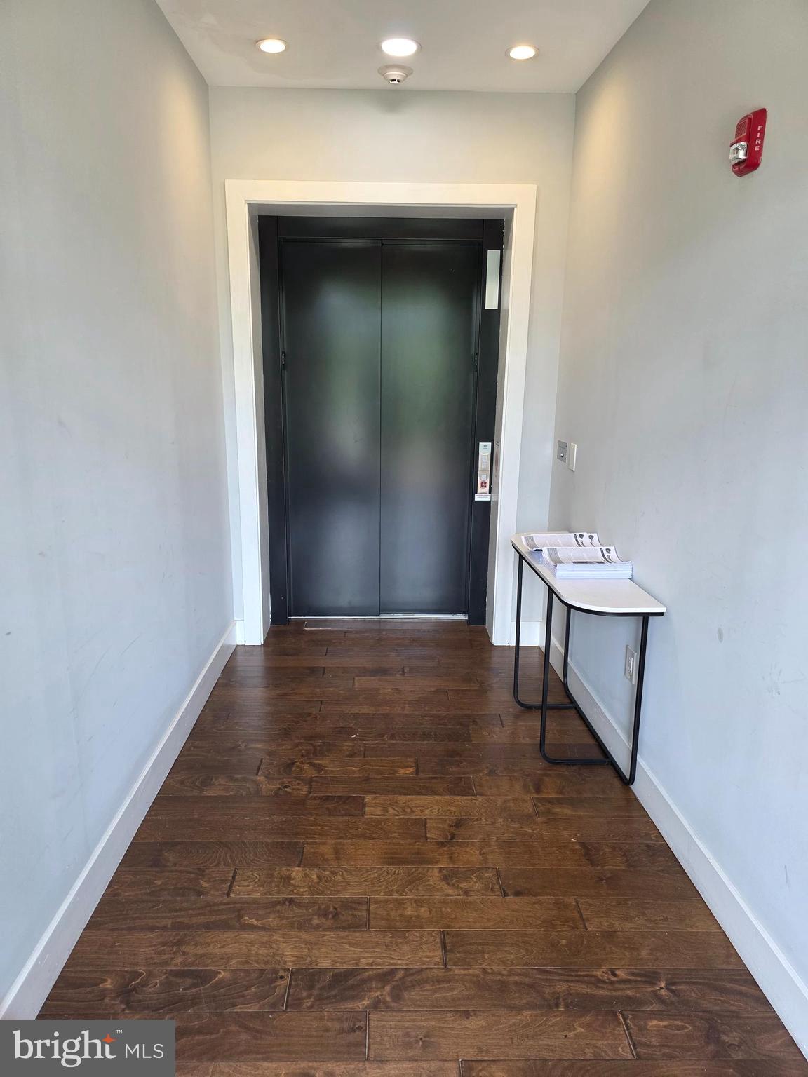 1101 Fern Street Northwest, Unit 301 Washington, DC 20012 - Photo 5 of 25 a view of an empty room with wooden floor and a window