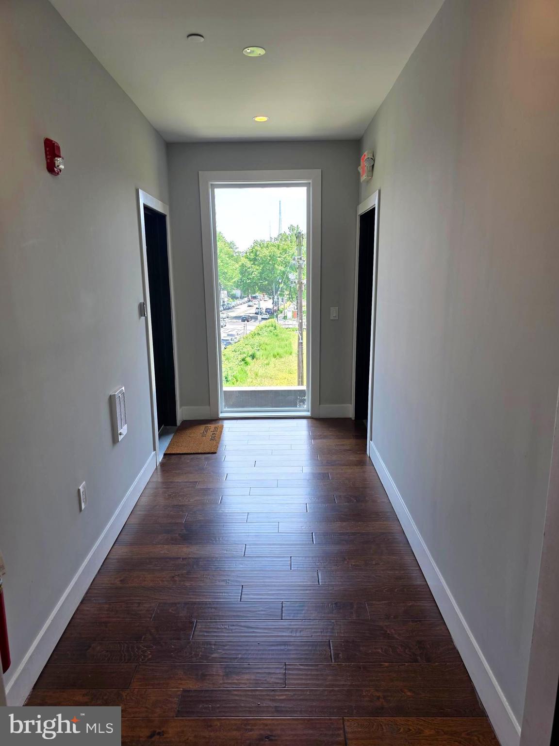 1101 Fern Street Northwest, Unit 301 Washington, DC 20012 - Photo 7 of 25 a view of an empty room with wooden floor and a window