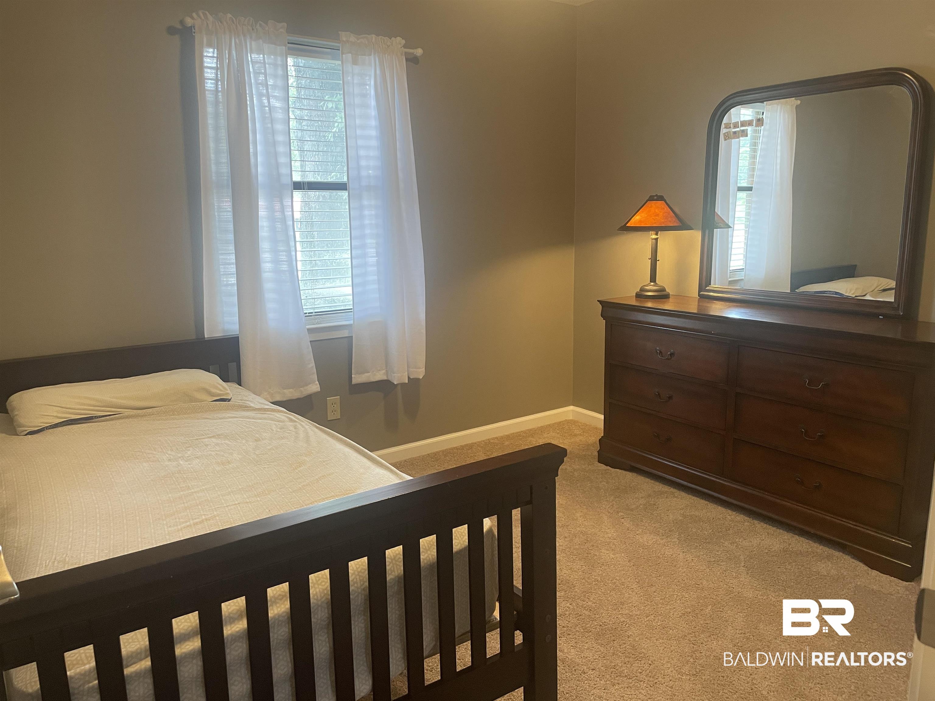 2274 Foshee Road Brewton, AL 36426 - Photo 14 of 23 Bedroom featuring light carpet and multiple windows