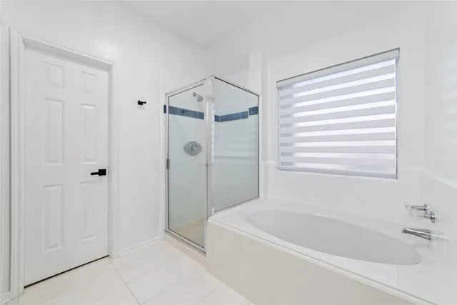 a white bath tub sitting next to a window