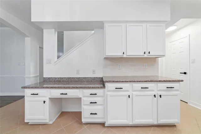 a view of cabinets with granite countertop