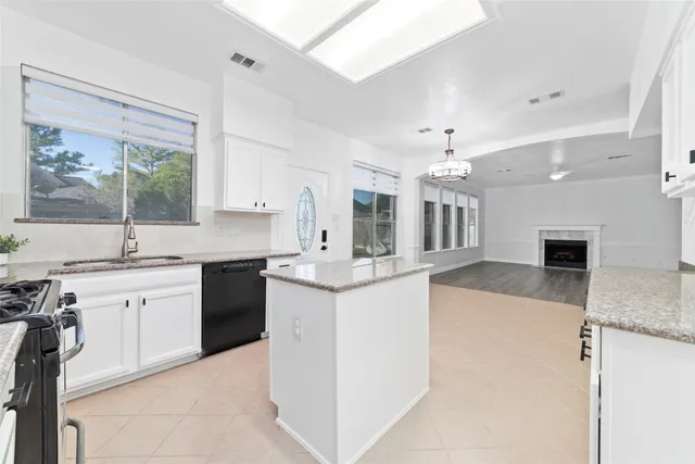 a large kitchen with kitchen island a sink stainless steel appliances and cabinets