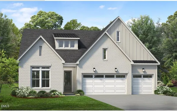 a view of a white house next to a yard with large trees