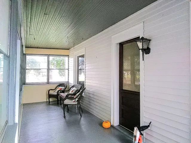 a view of a livingroom with furniture and a window