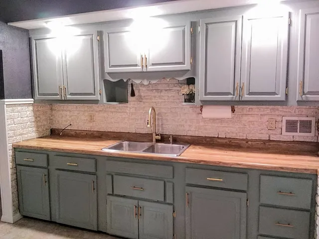 a kitchen with a sink and cabinets