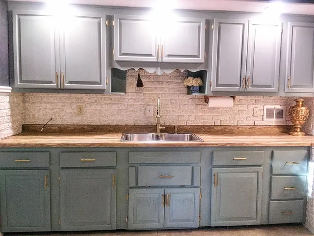a kitchen with cabinets appliances and a sink