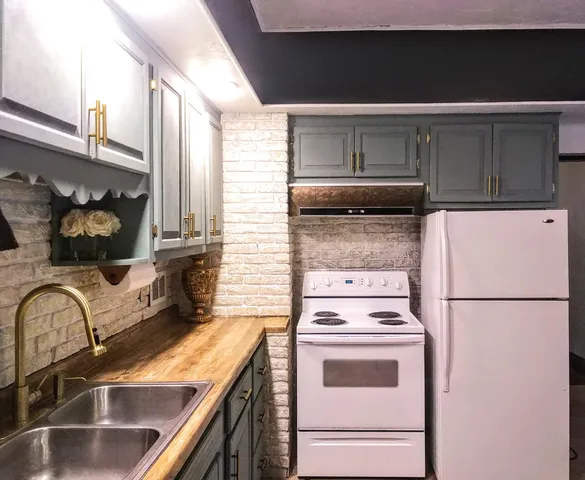 a kitchen with a stove and a refrigerator