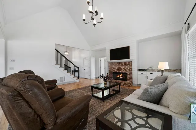 a kitchen with stainless steel appliances kitchen island granite countertop a table chairs stove and refrigerator