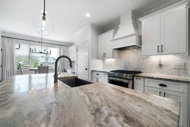 a kitchen with stainless steel appliances a refrigerator and microwave