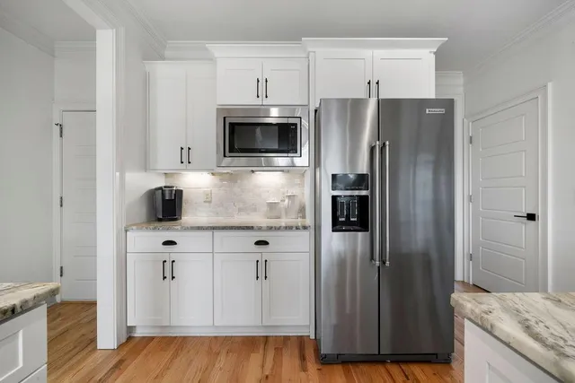 a view of a dining room with furniture and a window